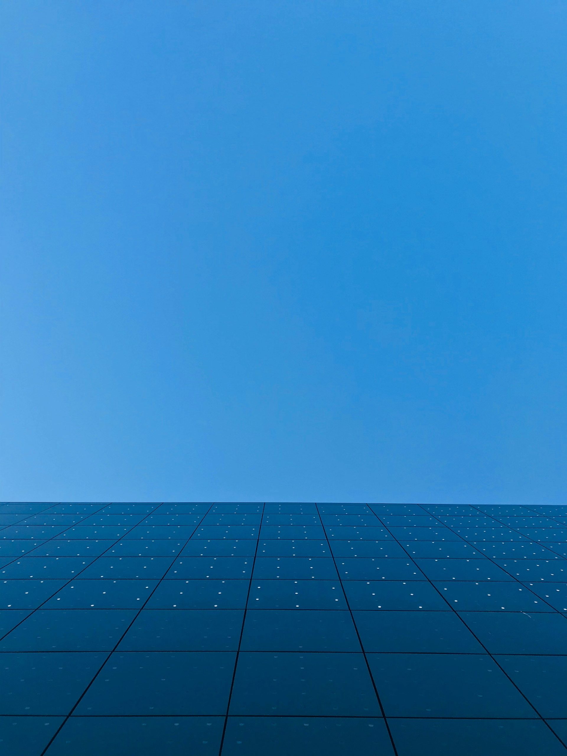 blue sky over black and white concrete building